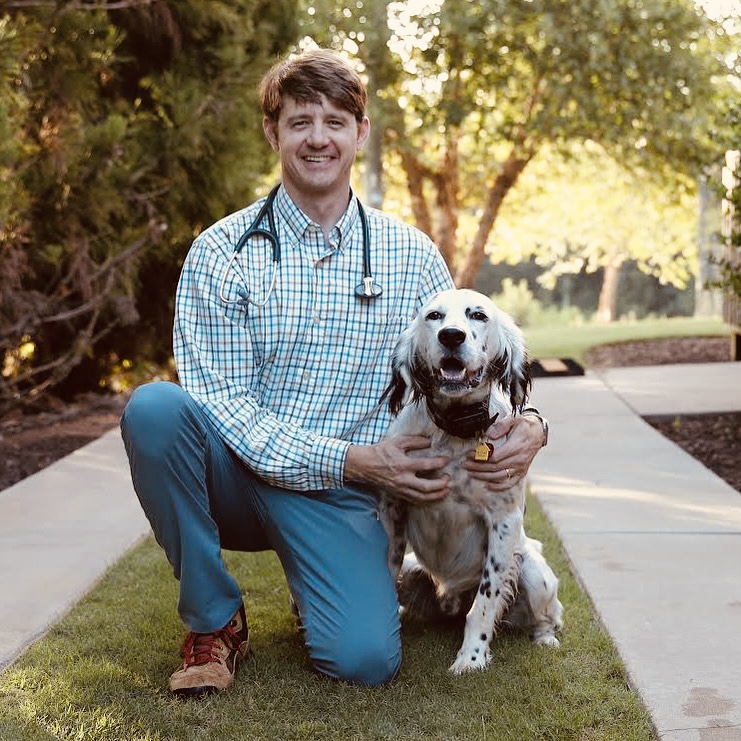 BAF3CA9F-8D6B-425B-9A56-30C291F7F274 dr jackson walker holding a dog at Walker Canine Care